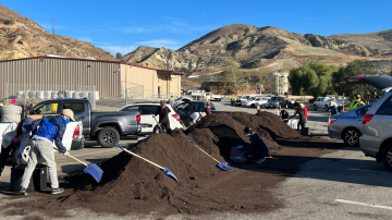 OC Waste & Recycling employees shoveling compost