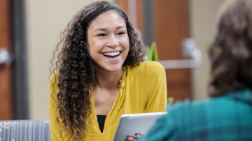 Young Social Worker sits with colleague