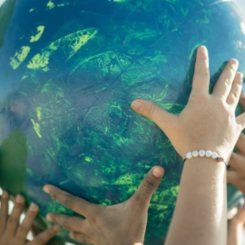 hands holding up a globe