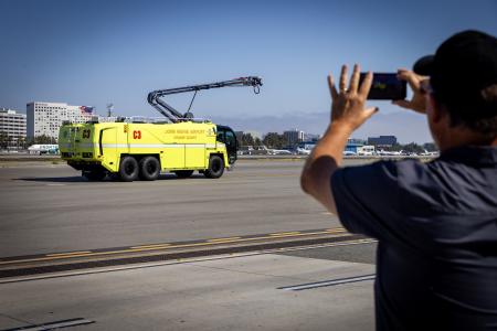 A man taking a photo of a new Crash 3 vehicle from a distance