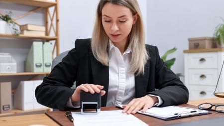 Image of a woman providing apostille service with a stamp